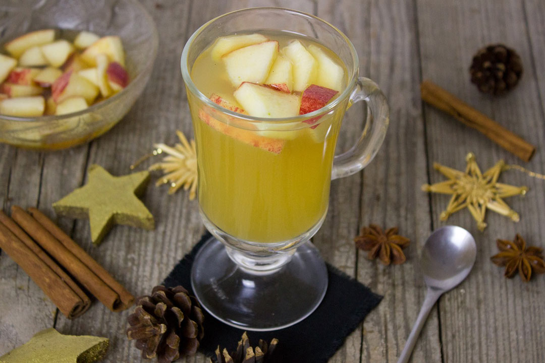 Apple rye punch in a glass with apples on top