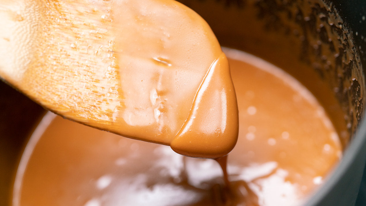 caramel sauce on a wooden spoon