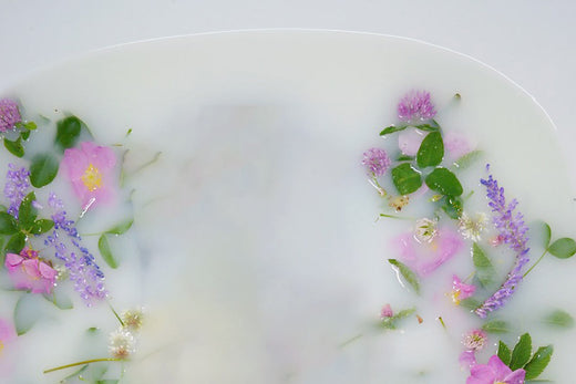 Milk and lavender bath with flowers in it