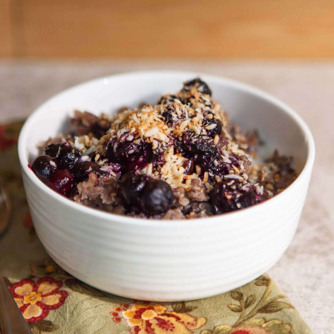 buckwheat cereal topped with blueberries, honey, and toasted coconut