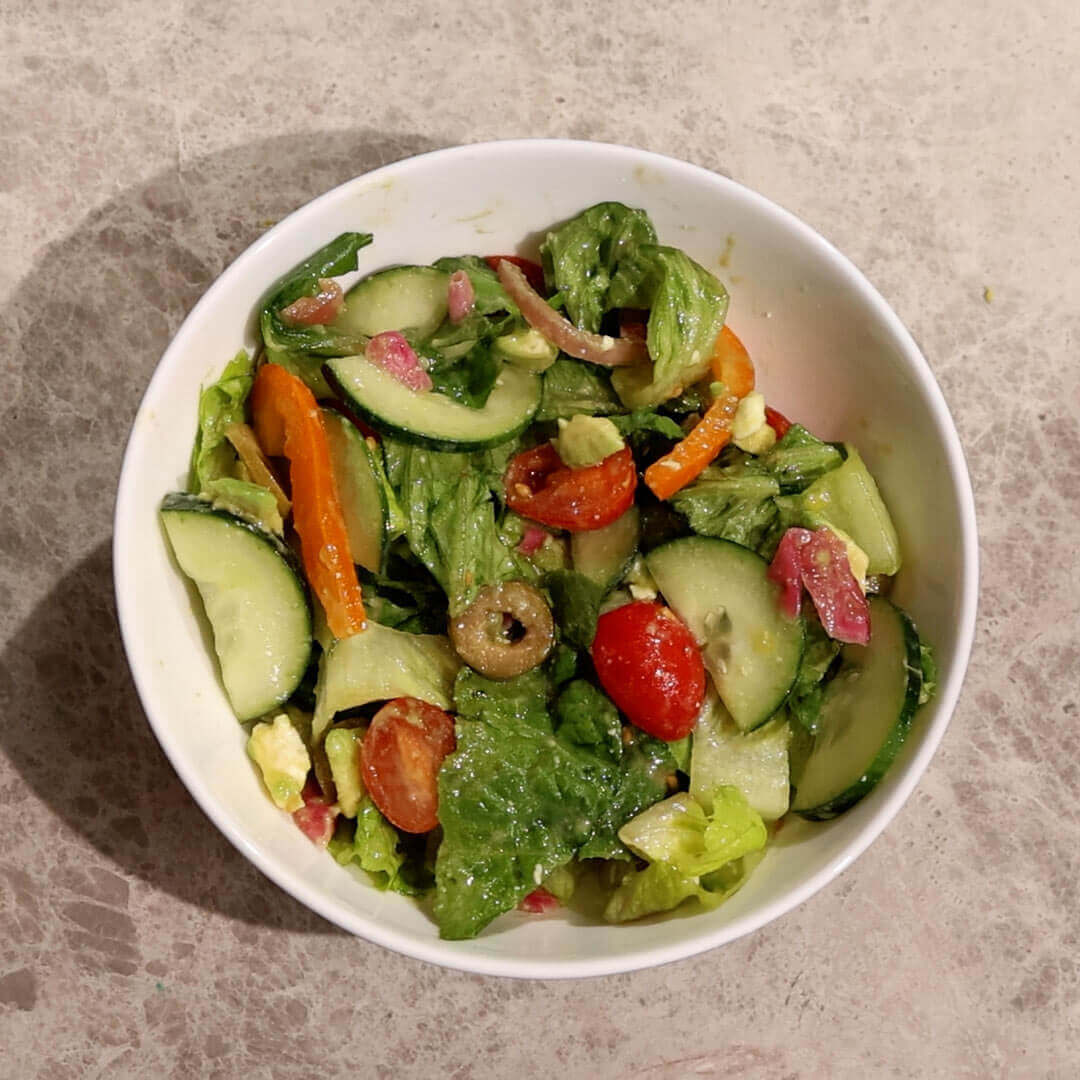 a salad with homemade citrus miso dressing on top