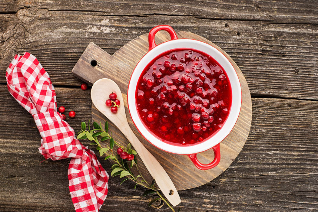 cranberry relish in bowl on wood with gingham napkin