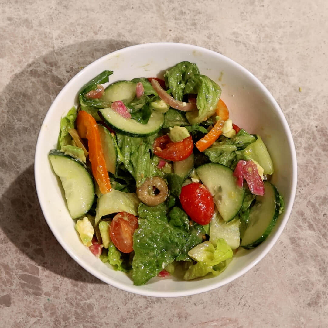 a salad with homemade citrus miso dressing on top