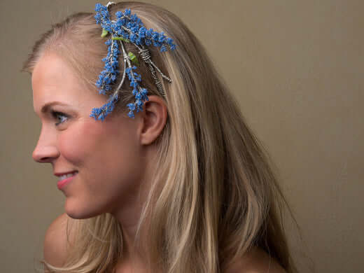 Woman with soft shiny blonde hair and flower - results of honey hair mask treatment