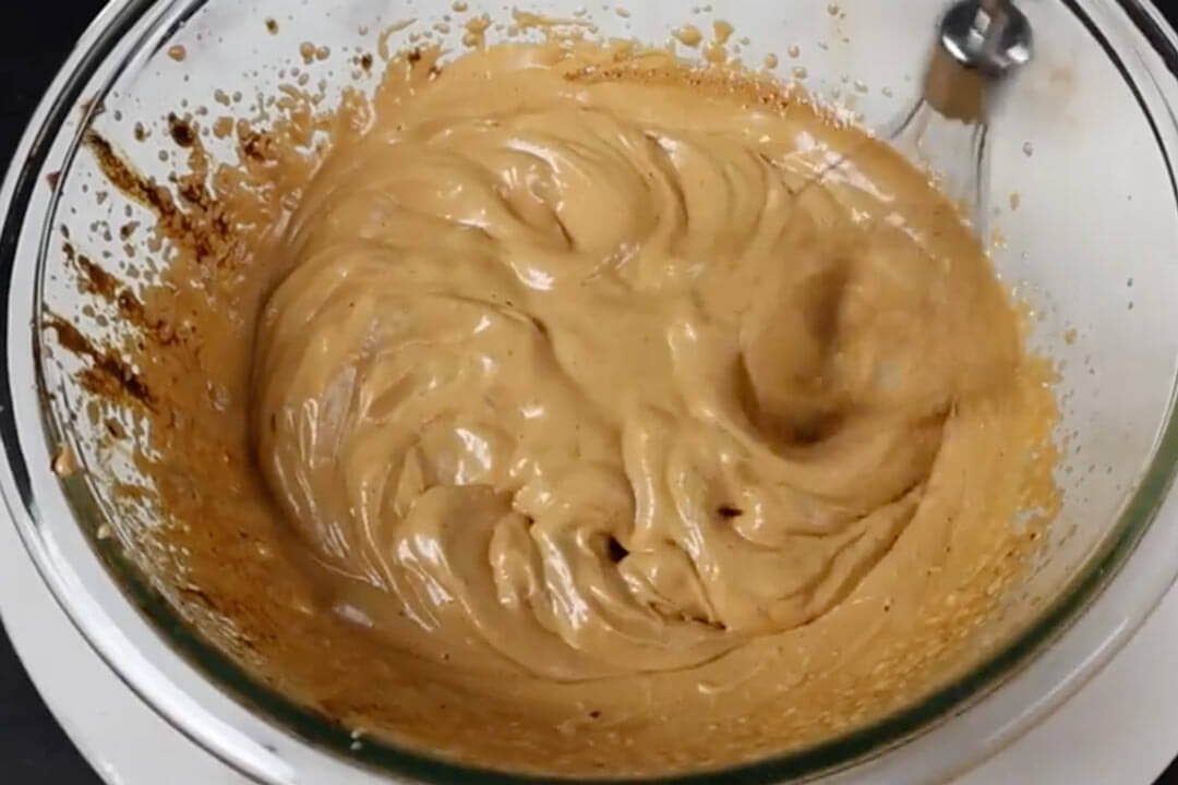 whipping honey in a bowl with a mixer