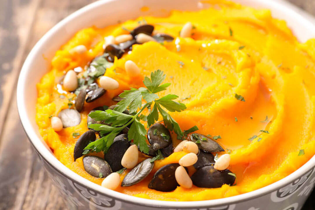 healthy mashed sweet potatoes with nut and fruit garnish
