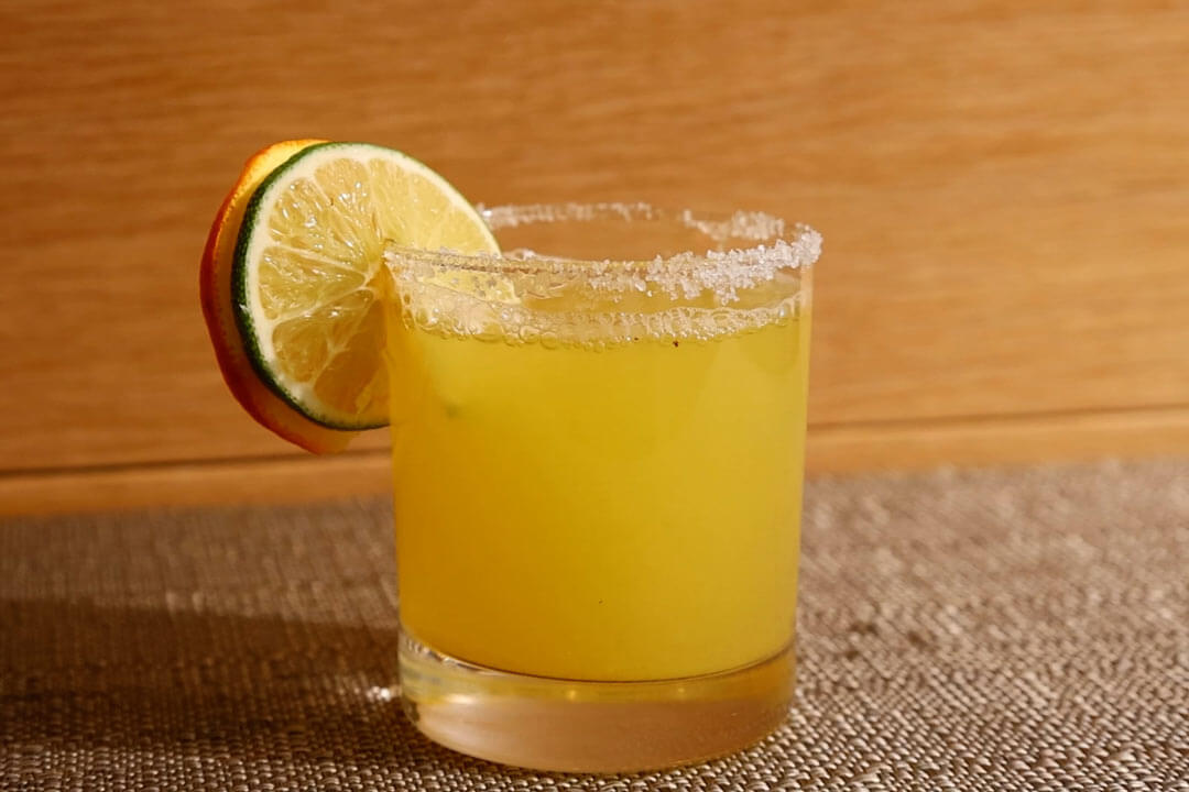 Easy Skinny Margarita on table with citrus garnish and salt rim