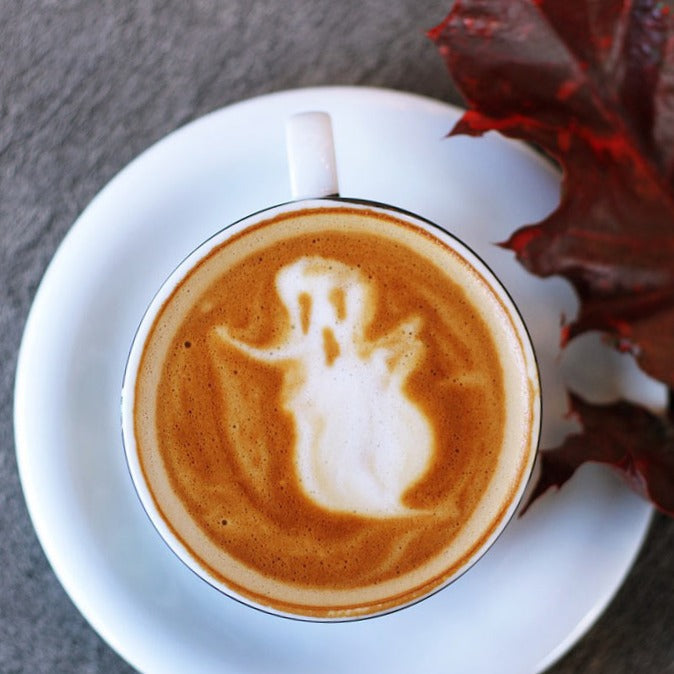 Aerial view of a pumpkin spice latter with foam art of a ghost 