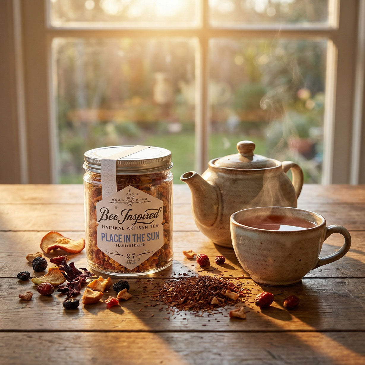 A jar of Bee Inspired Place In The Sun tea on a table, with a steaming mug of tea
