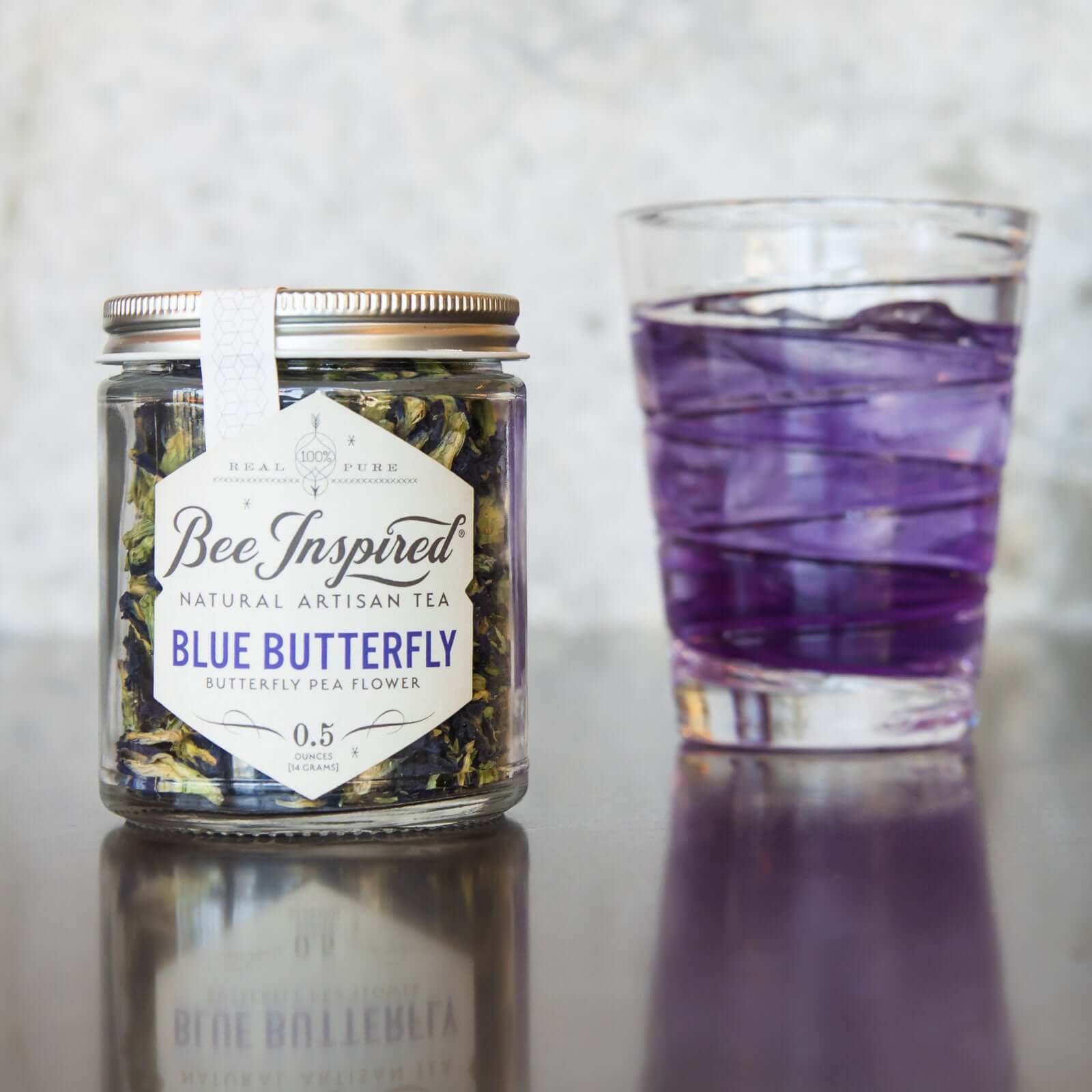 Jar of Blue Butterfly Pea Flower Tea next to a cup with brewed blue iced tea