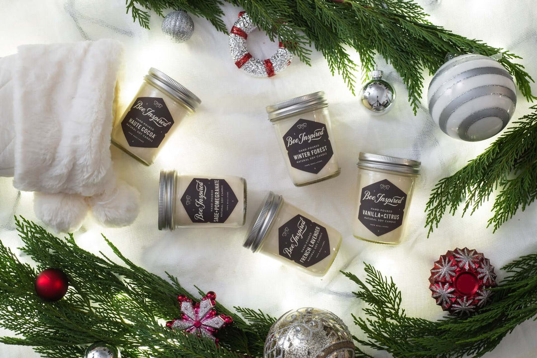 Bee Inspired Jelly Jar Candles coming out of a white stocking with festive decorations around