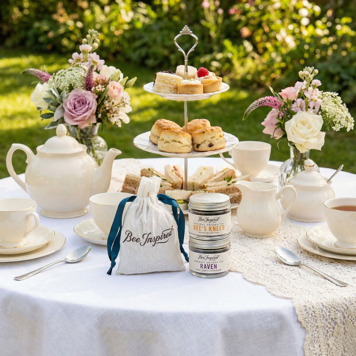 Bee Inspired Tea Party Favors and Tea set with scones, teacups, and flowers on a table outdoors.