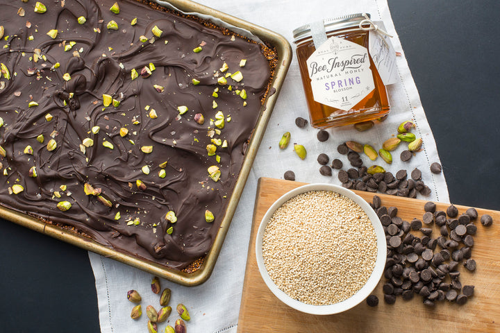 Tray of honey pistachio chocolate bark with Spring honey from bee inspired honey retail store in owings mills, pistachios, and chocolate chips 