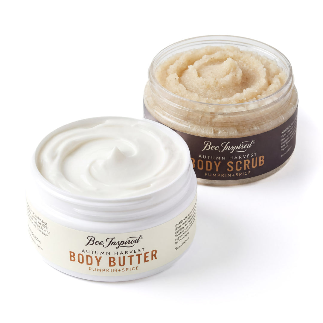 Two containers of 'Bee Inspired' body butter and scrub on a white background