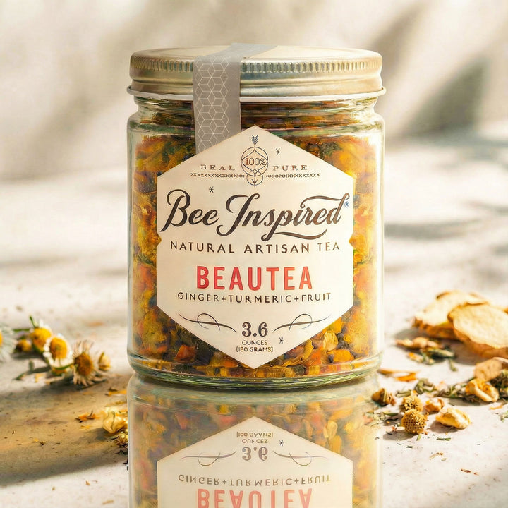 'Bee Inspired' Beautea tea on a reflective surface.