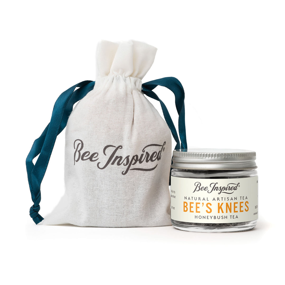 Jar of 'Bee's Knees' tea with a drawstring bag labeled 'Bee Inspired' on a white background