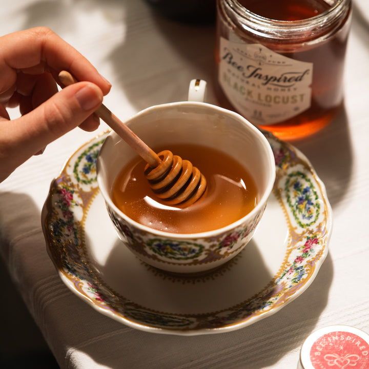 Jar of Black Locust honey with honey dipper 