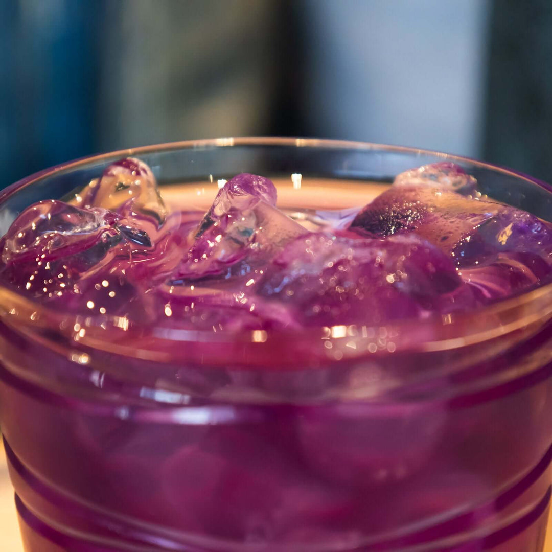 close-up of glass of fuchsia Blue Butterfly iced tea