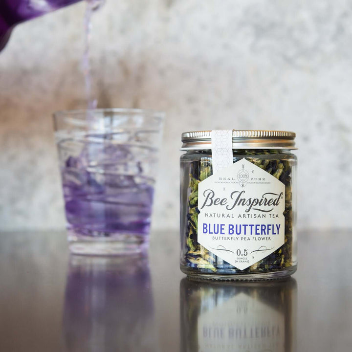 pouring a glass of iced Blue Butterfly tea 