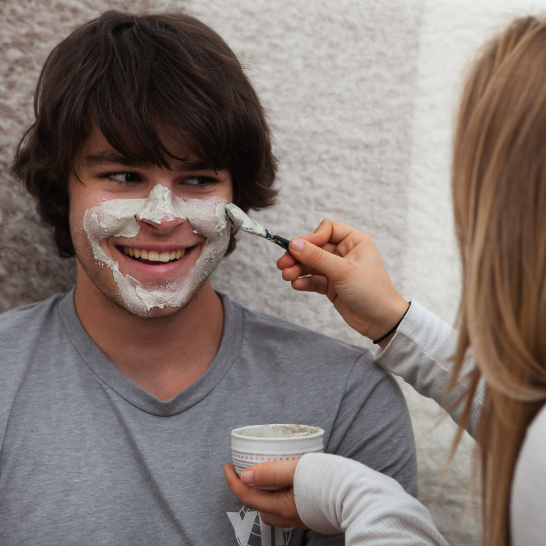 Emily putting the calming mask on Kevin's face