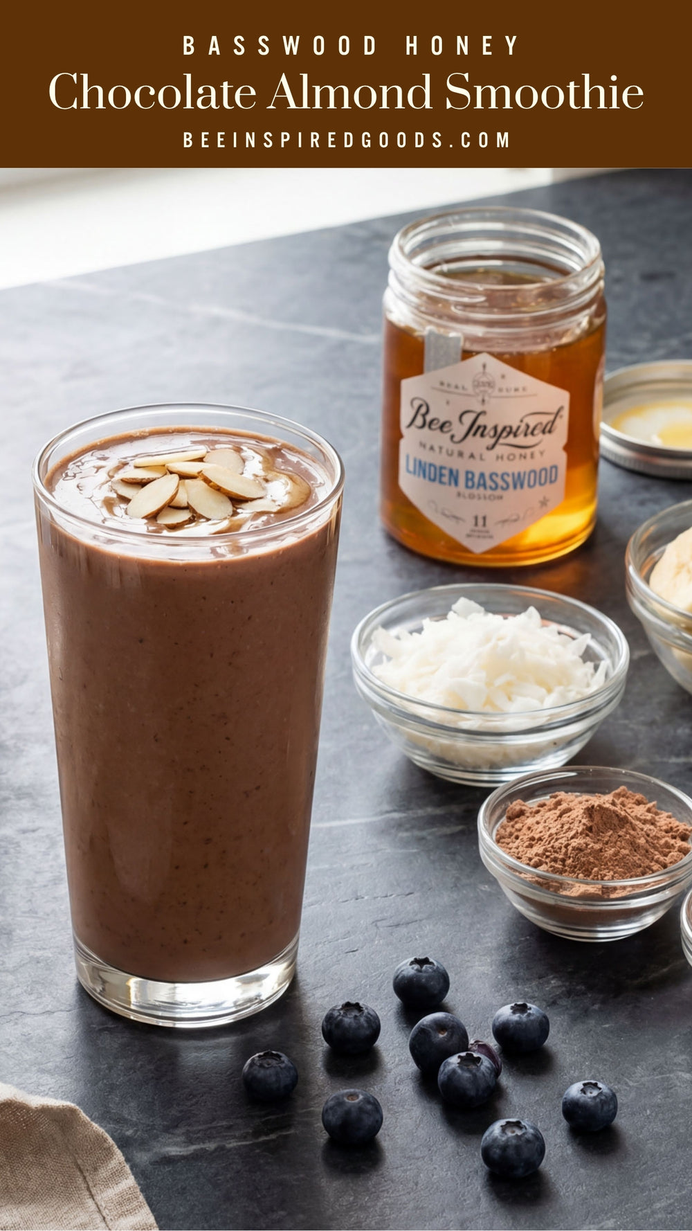 Tallpin of a chocolate smoothie topped with almonds, surrounded by ingredients