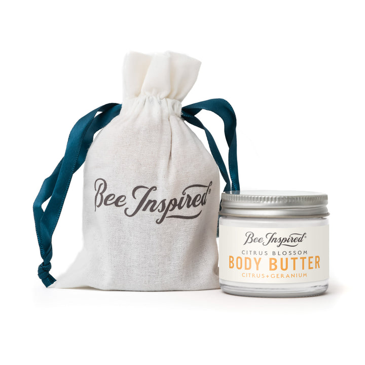 Jar of 'Bee Inspired' body butter with a matching drawstring bag on a white background