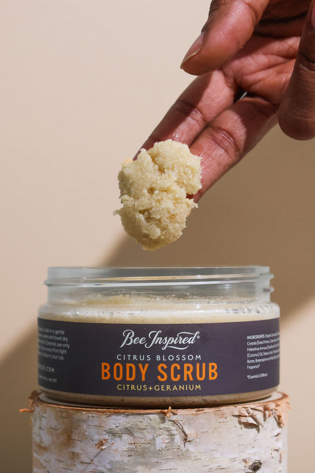 Taking Citrus Blossom body scrub from the jar