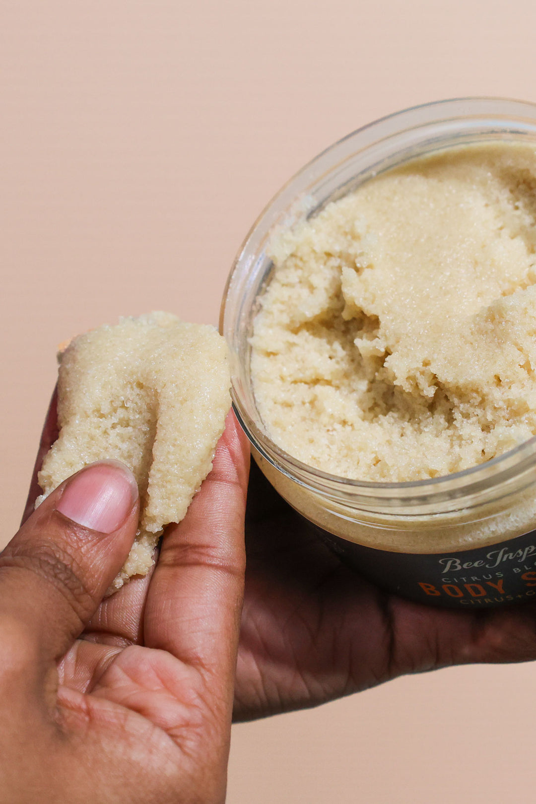 Taking Citrus Blossom body scrub from the jar