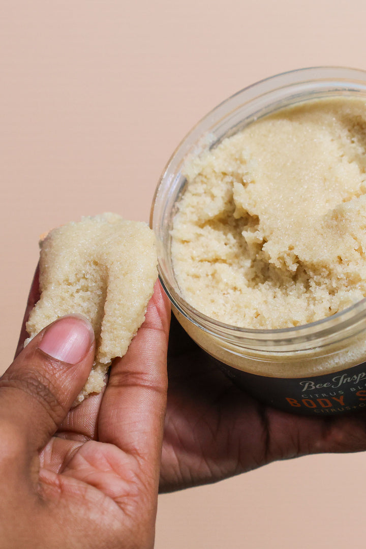 Taking Citrus Blossom body scrub from the jar