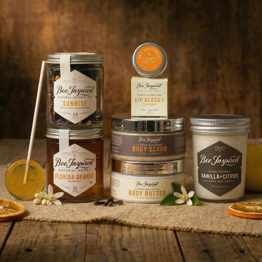 Collection of Bee Inspired skincare and beauty products on a wooden surface with a warm background.