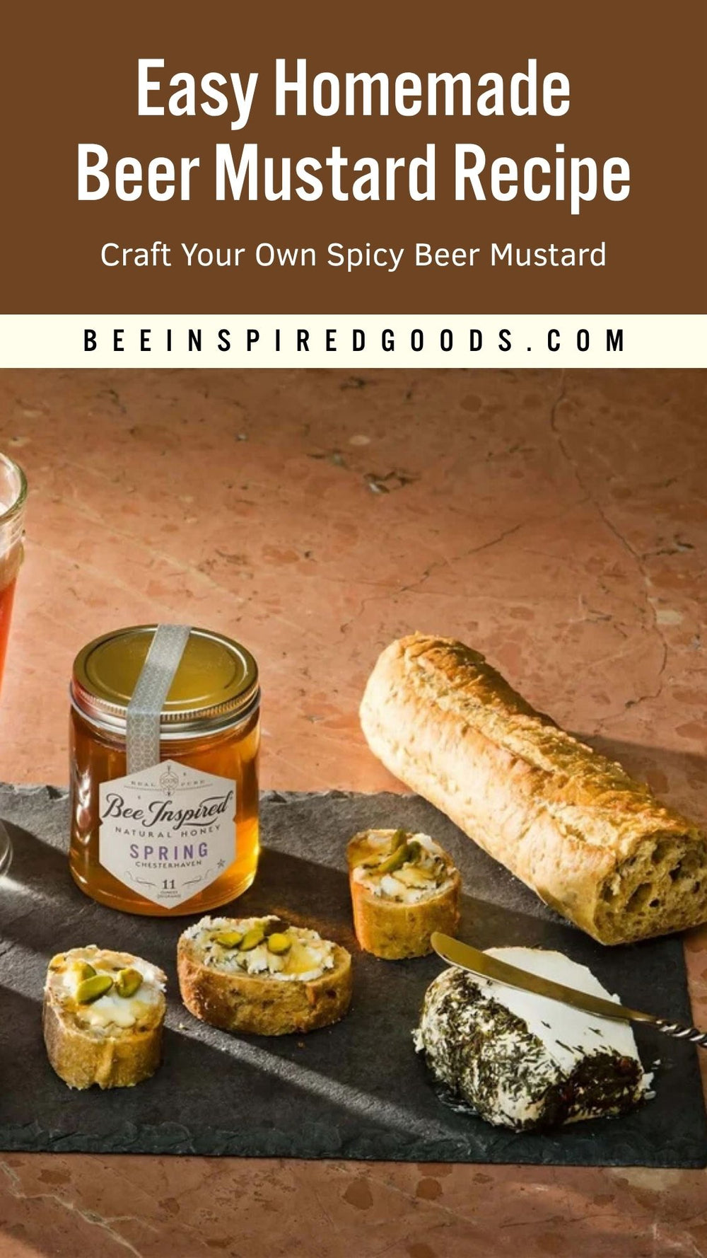 A recipe-style promotional image for Bee Inspired Goods featuring a jar of homemade beer mustard on a stone surface with bread and cheese slices. Large text at the top reads 'Easy Homemade Beer Mustard Recipe' and 'Craft Your Own Spicy Beer Mustard,' with 'BEEINSPIREDGOODS.