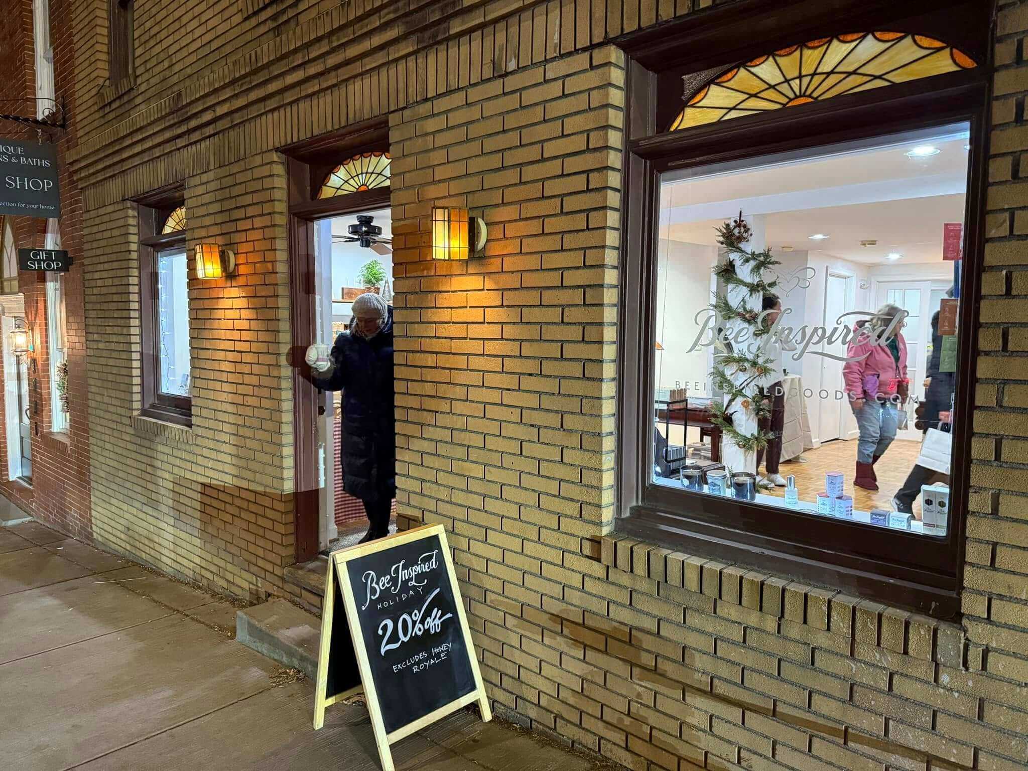 a customer leaving Bee Inspired store in Old Ellicott Cite white another customer browses inside