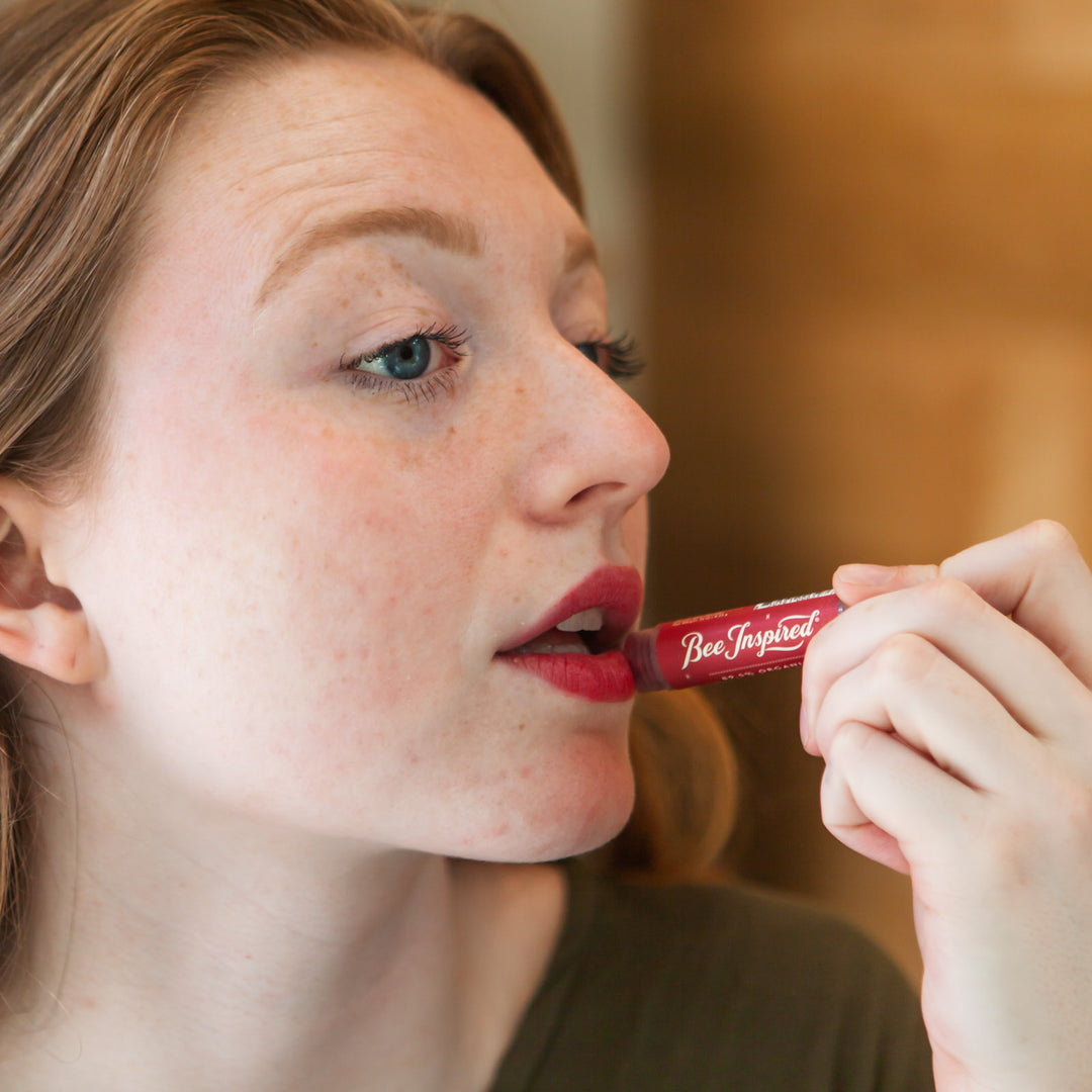 applying Bee Inspired cranberry lip tint