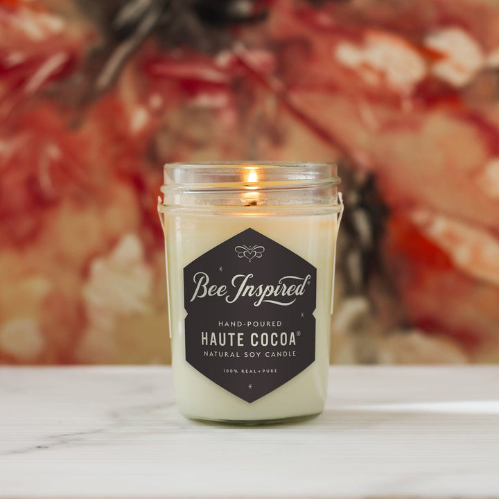 Haute Cocoa Soy Jelly Jar Candle in front of art