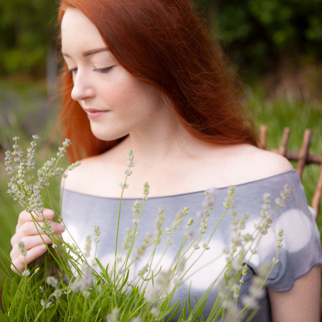 woman in a field smelling lavender