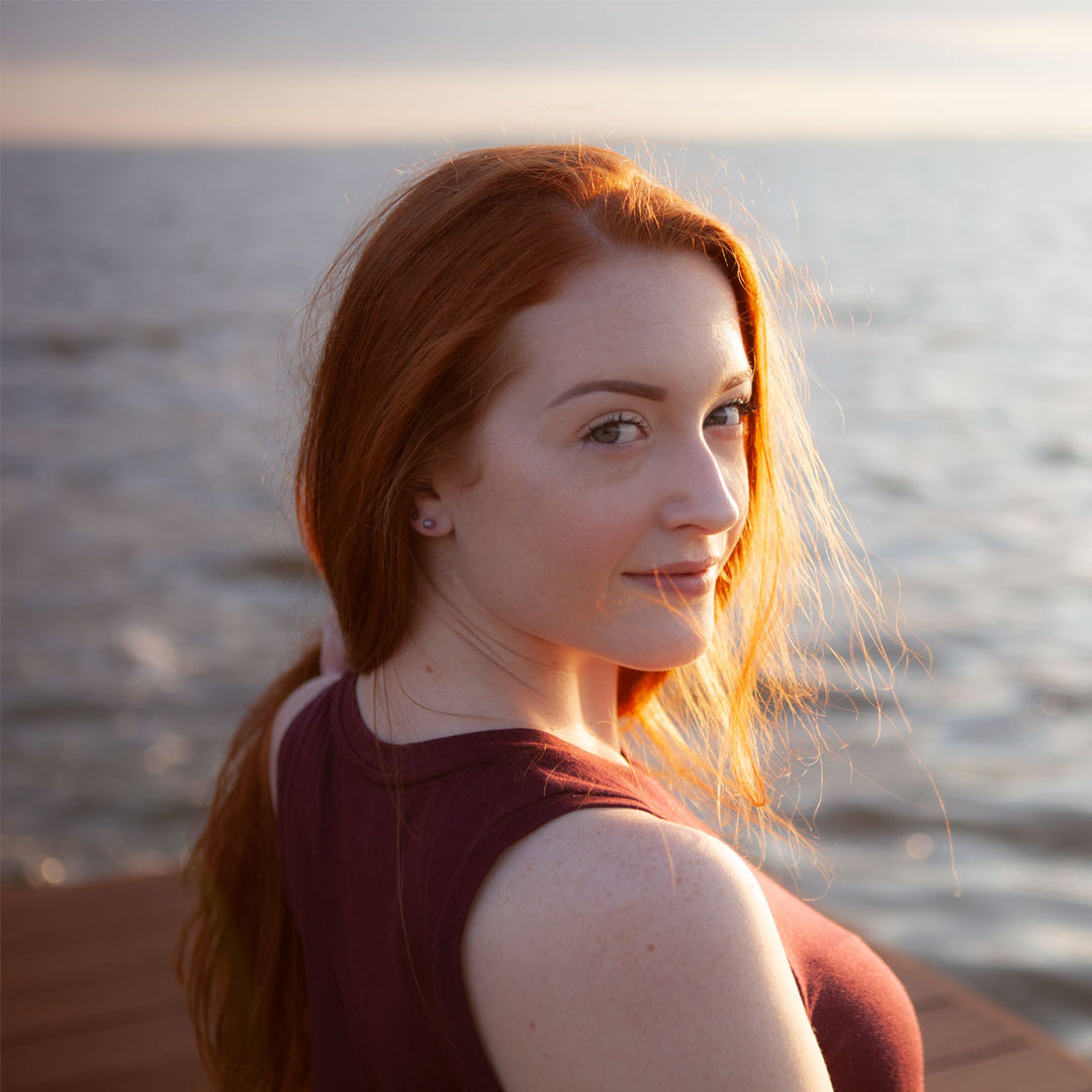 woman on a dock looking away from the water