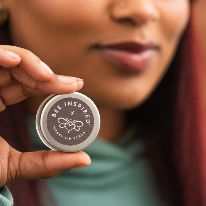 Woman holding honey lip scrub 