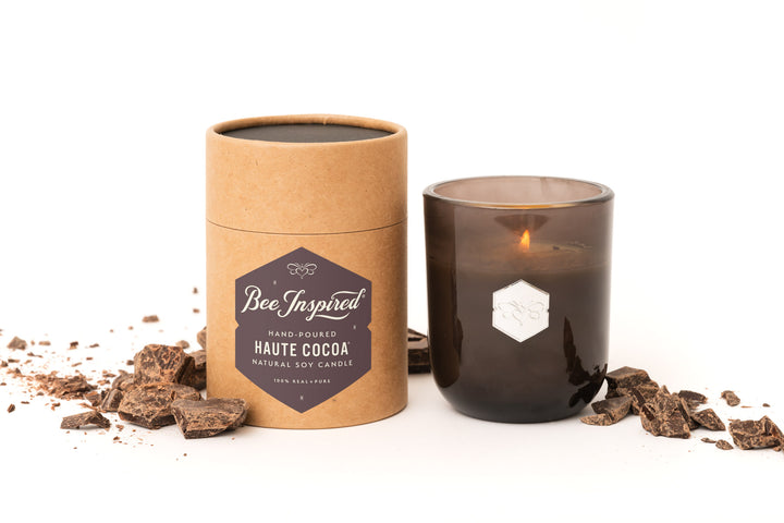 Haute Cocoa luxe candle with chocolate on white 