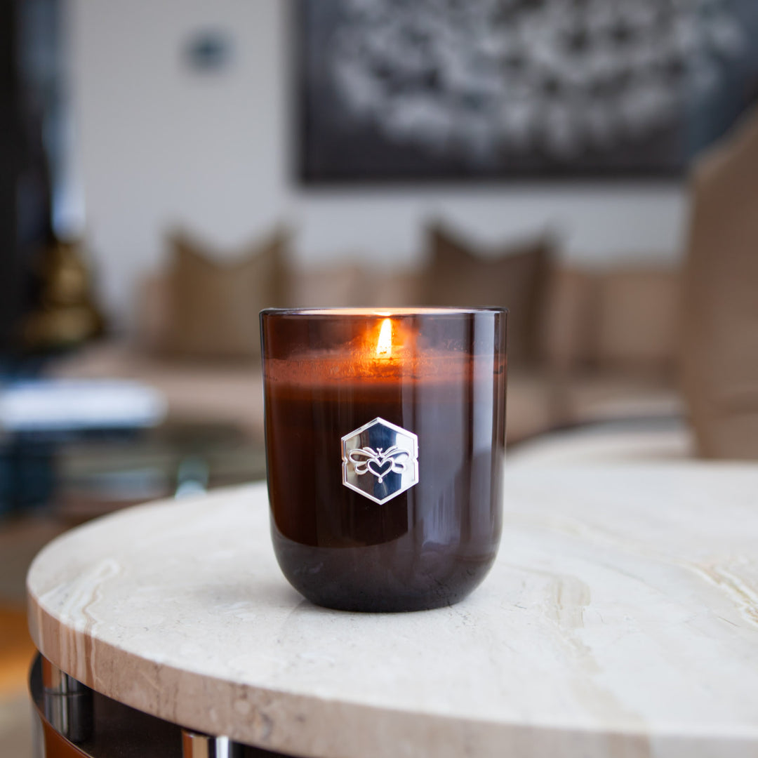 luxe candle from bee inspired honey retail store in owings mills on a marble table 