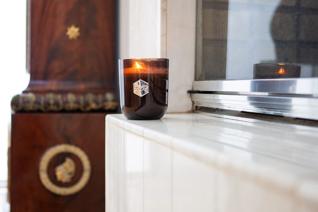 Blush Apricot Luxe Candle on fireplace ledge