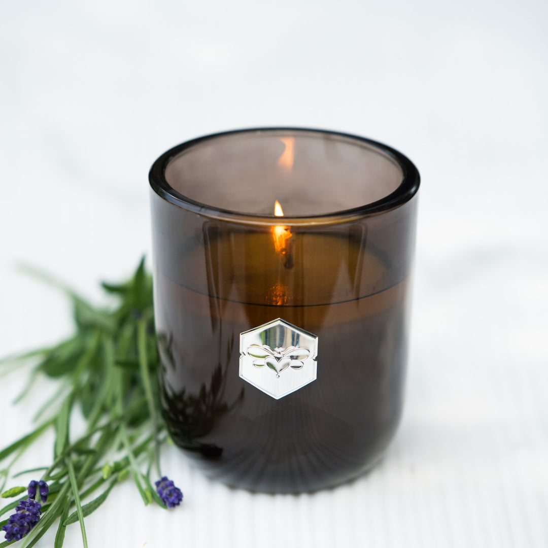 Smoky brown candle with a logo on a white background