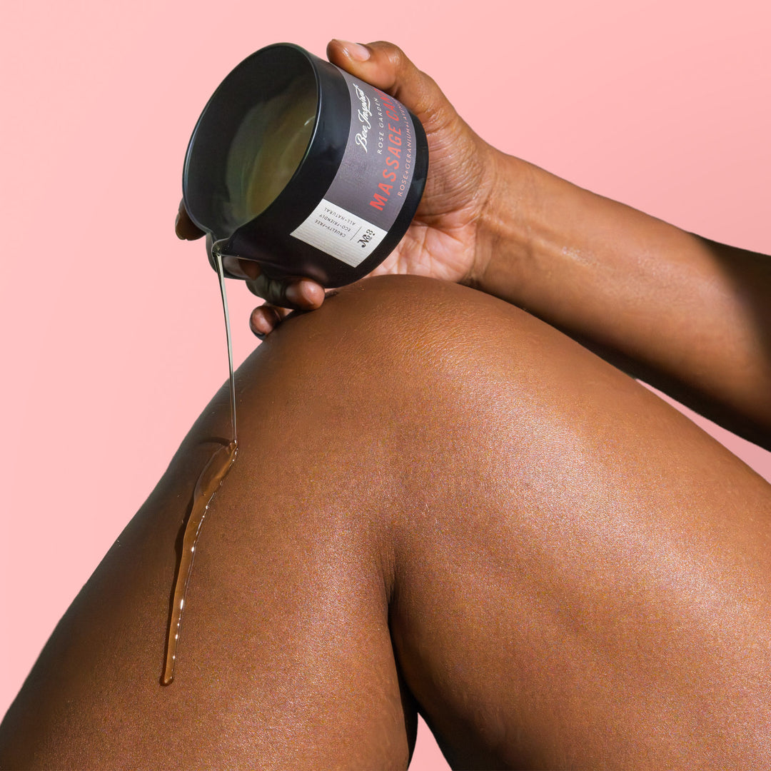 pouring Rose Garden massage candle oil on leg