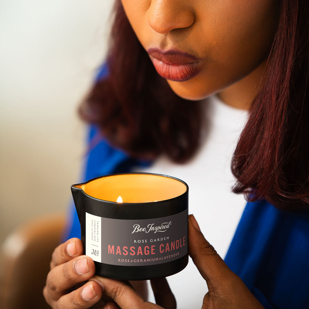 blowing out flame of Rose Garden massage candle 