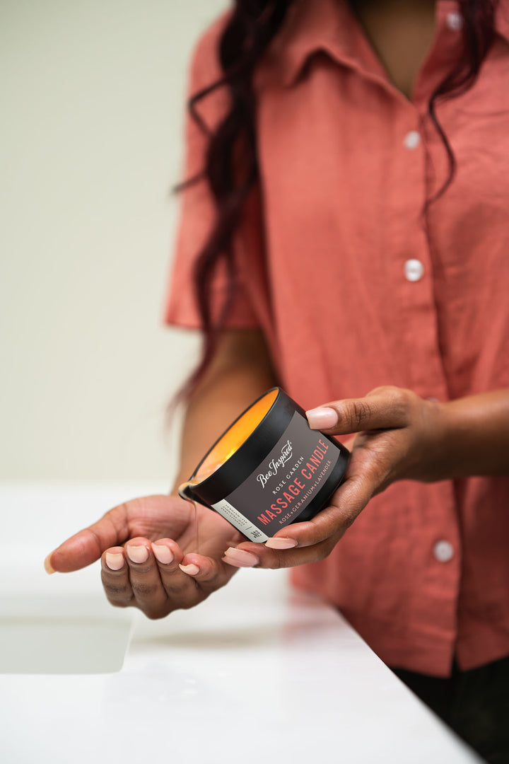 pouring oil of Rose Garden massage candle onto hand