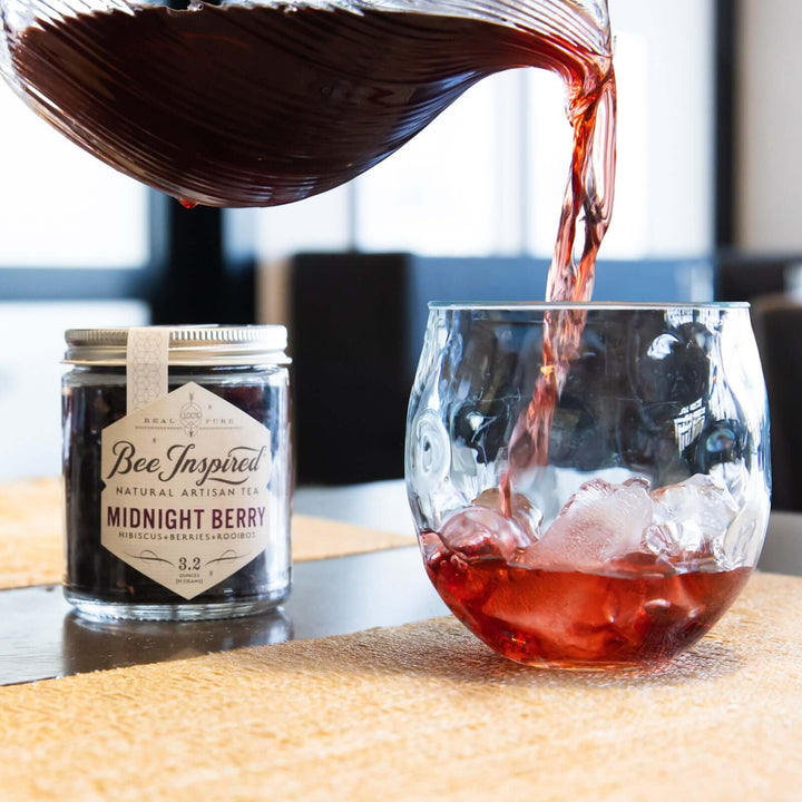 pouring a glass of Midnight Berry iced tea