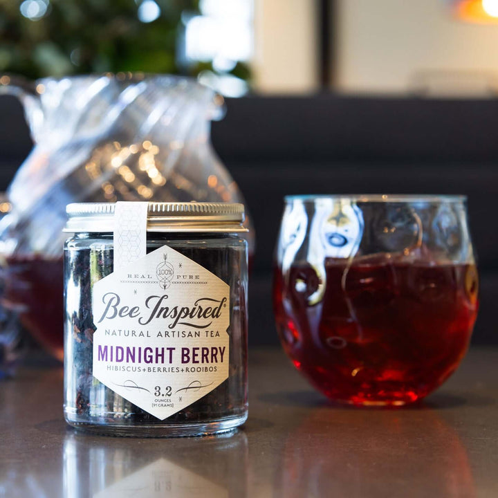 Midnight Berry loose-leaf tea and a glass of iced tea