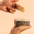 fingers with a scoop of nectar and honey body scrub