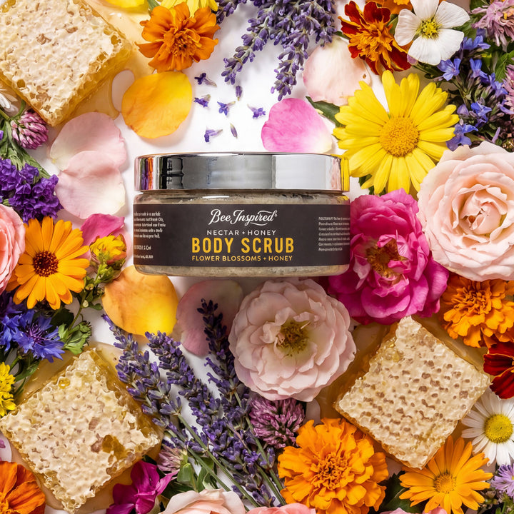 BeeInspired Nectar Honey Body Scrub surrounded by flowers and honeycomb