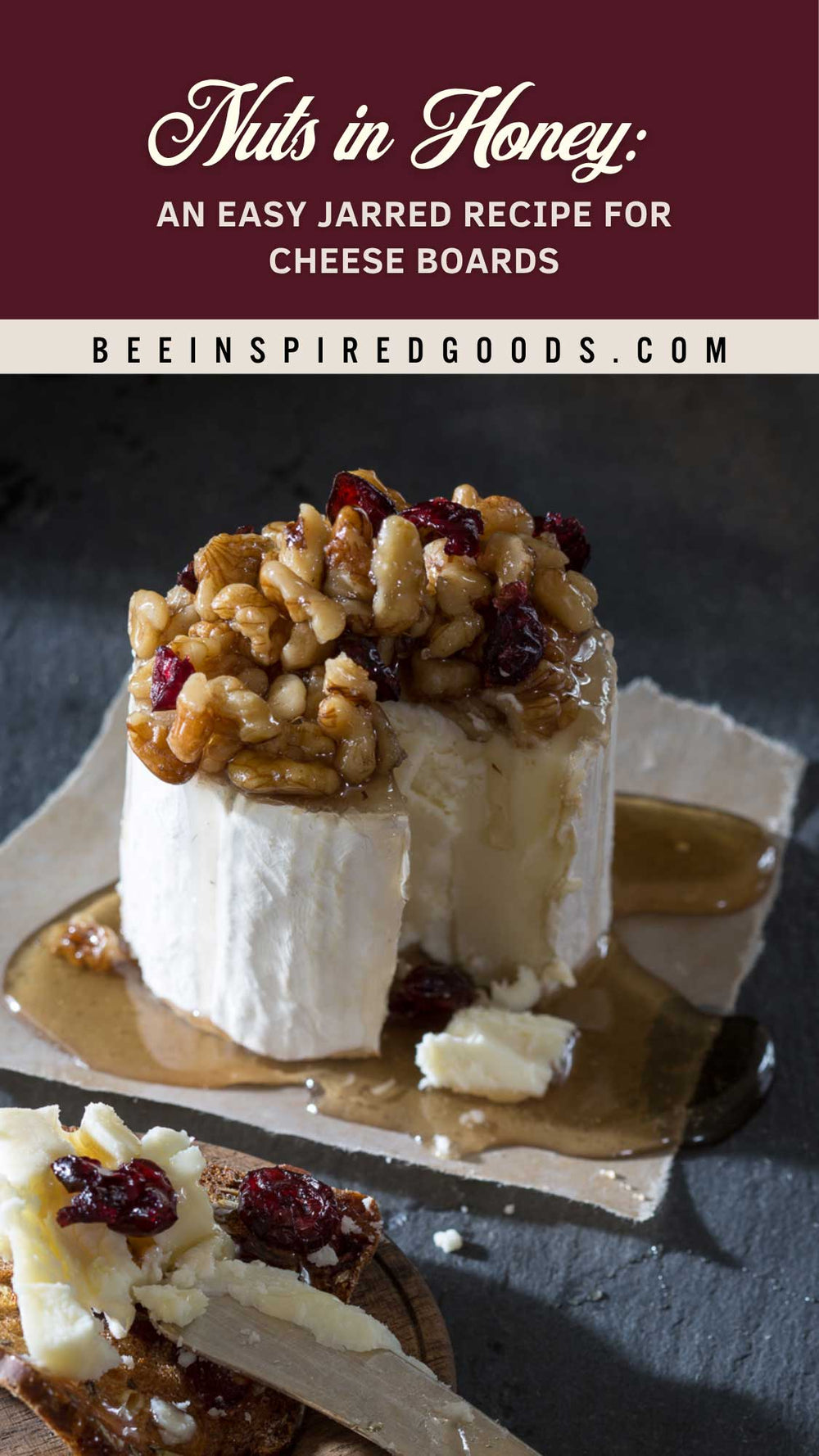 A jarred cheese board recipe dessert topped with walnuts and dried cranberries, shown on a dark slate surface with syrup pooling around it. Text at the top reads 'Nuts in Honey: An Easy Jarred Recipe for Cheese Boards' and 'BEEINSPIREDGOODS.