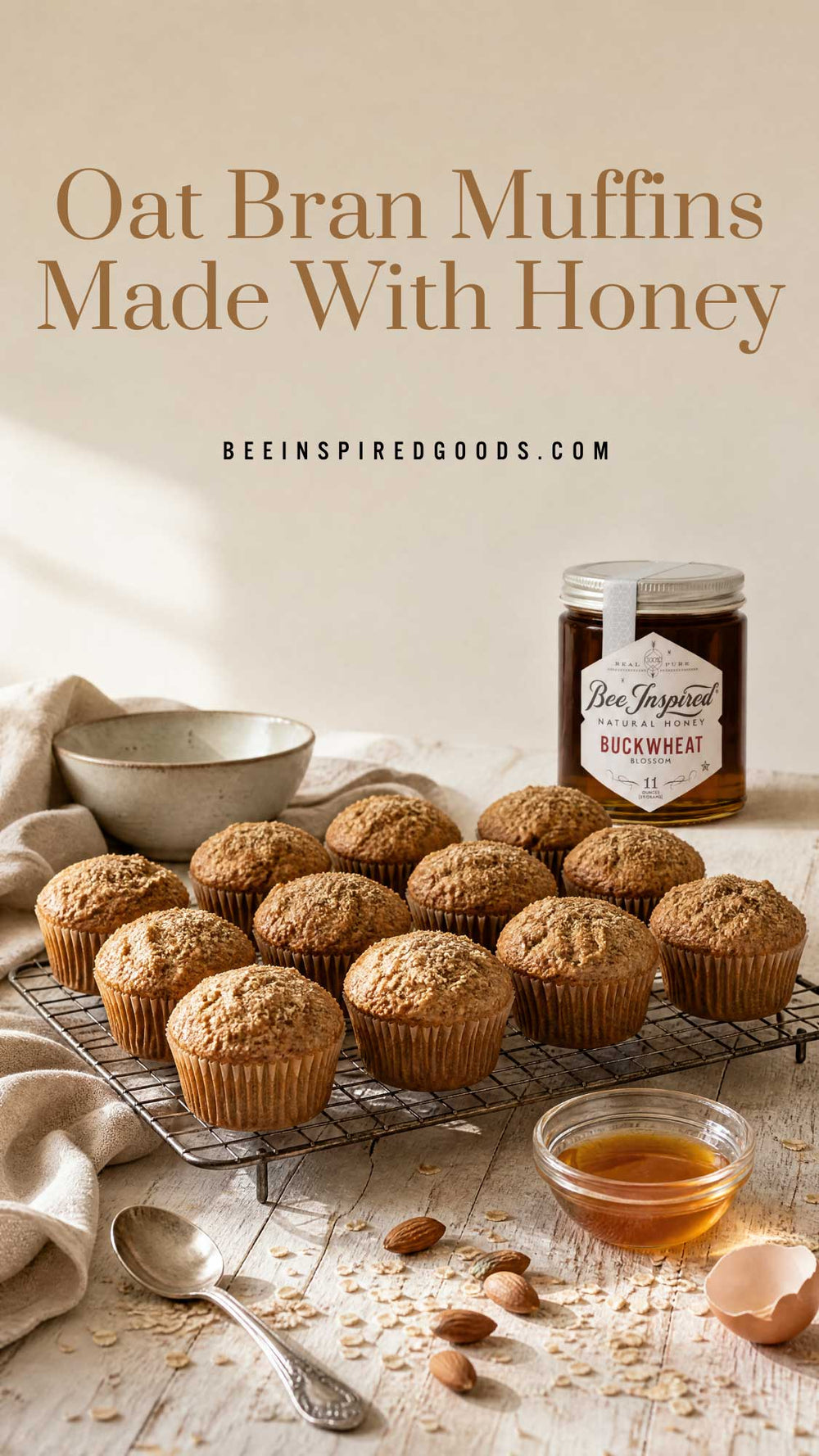 Oat bran muffins cooling on a wire rack beside a jar of honey and a small bowl, with the text 'Oat Bran Muffins Made With Honey' and 'BEEINSPIREDGOODS.COM' above.